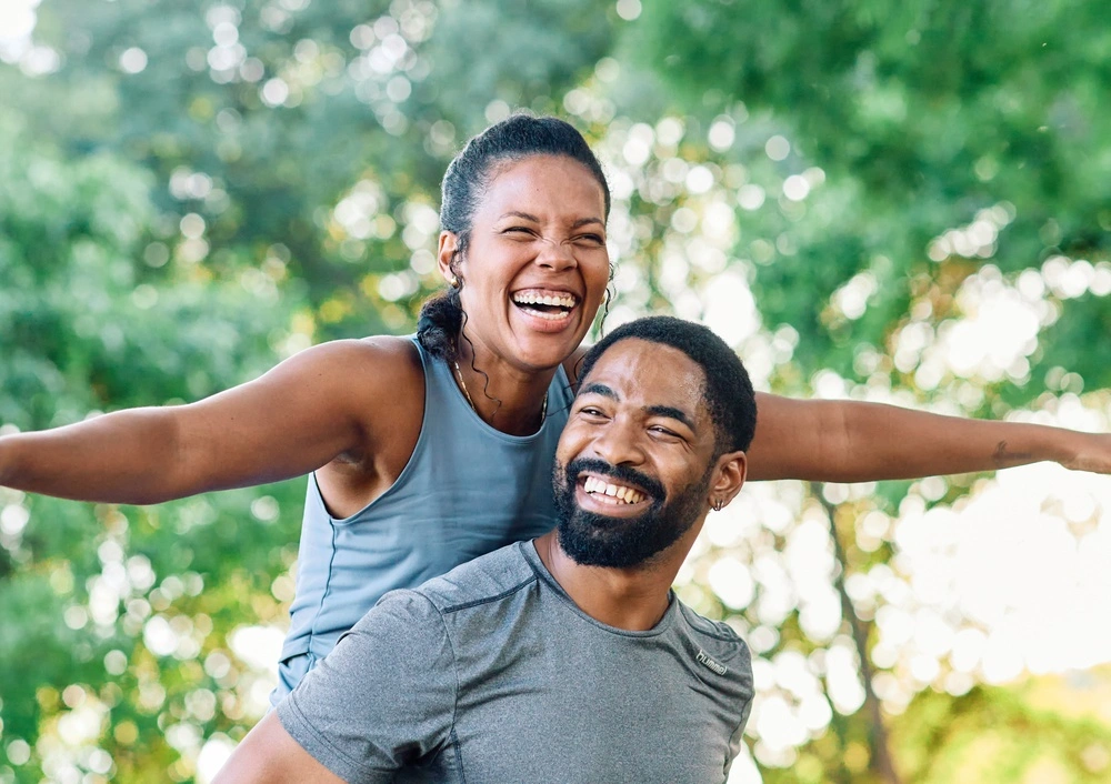 A happy couple enjoying the benefits of healthy smiles